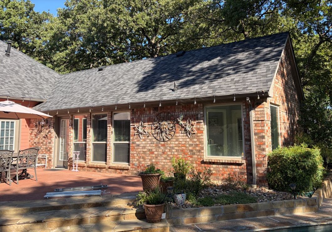 Brick home before window tint, interior visible through the windows