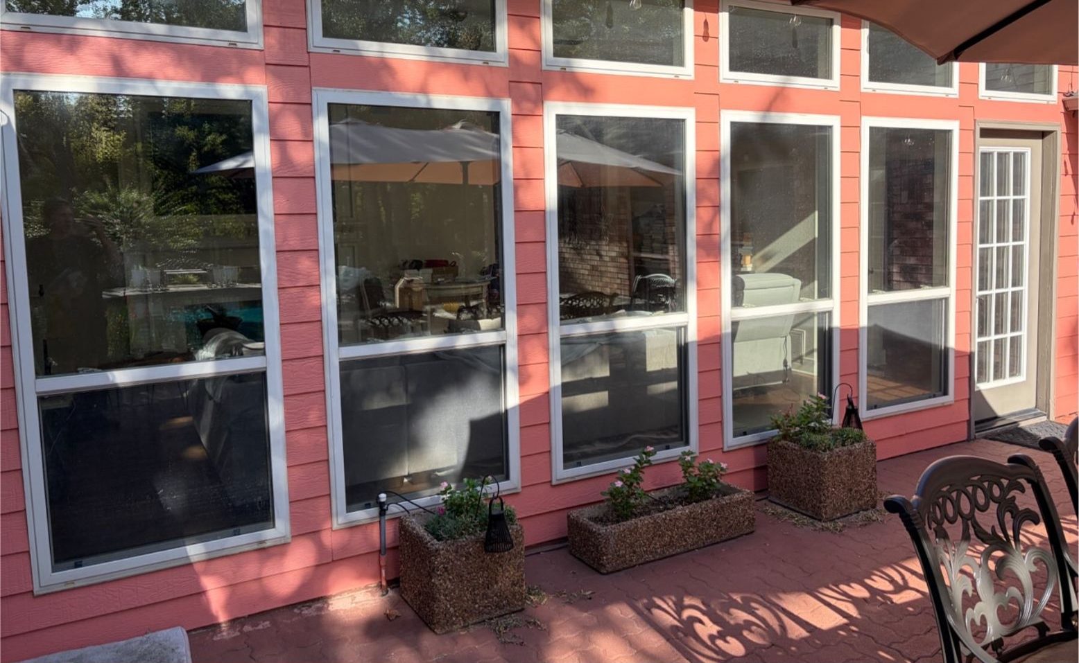 Patio windows before tint, living room visible from outside